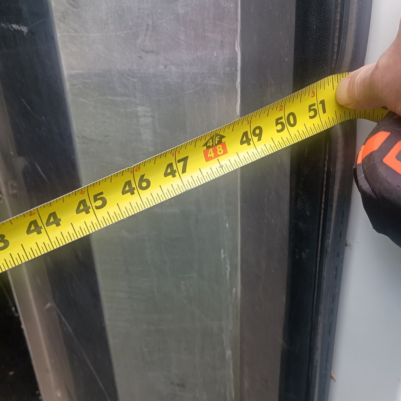 Tape measure showing 48–50 inches across the sliding side door opening