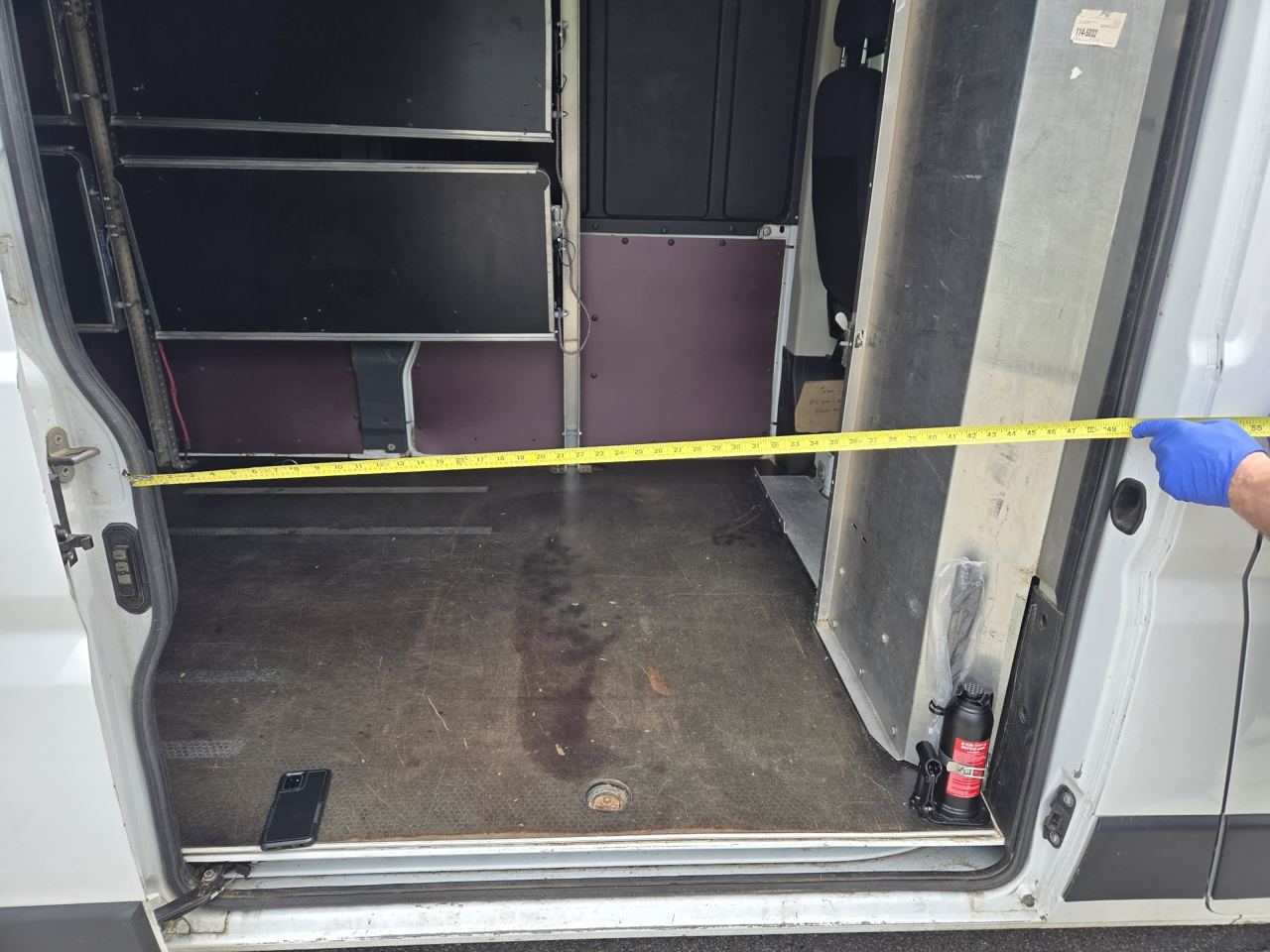 Driver measuring the sliding side door opening width
