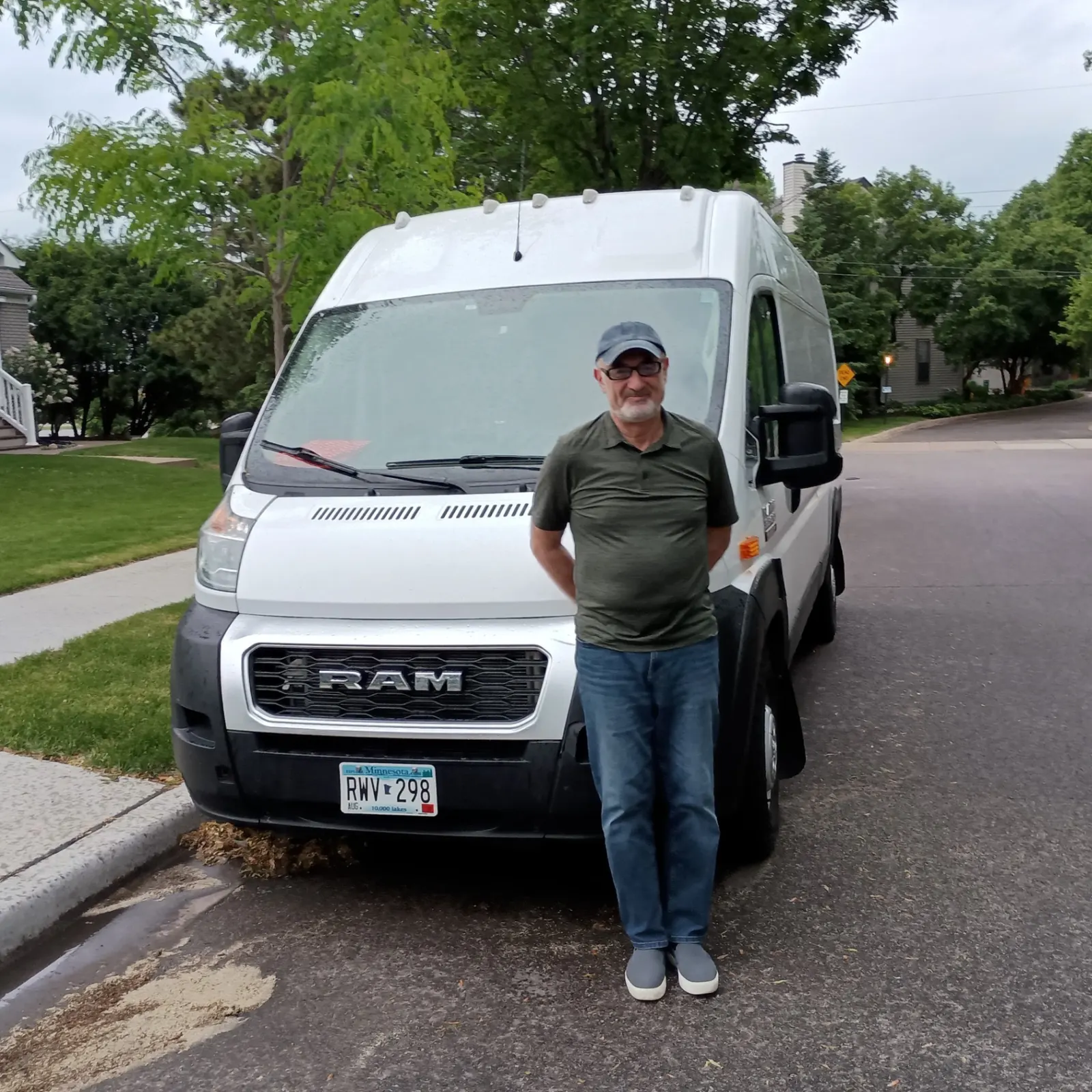 Sergei Khazanovich — founder and lead driver of Continent Logistics LLC standing next to a RAM ProMaster 3500 in Saint Louis Park, Minnesota